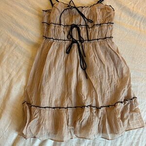 Beige Dress wwith Black Bows and Accents